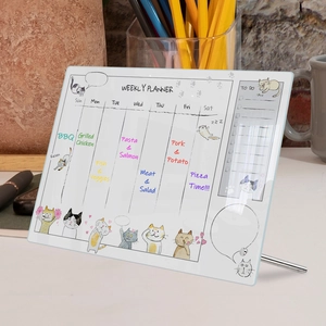 Detail view of acrylic weekly planner with cat illustration and sturdy metal stand