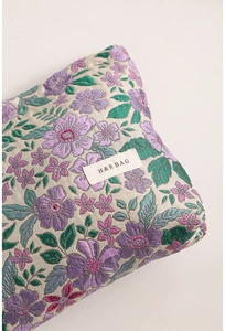 Detail of vintage floral jacquard fabric with high-quality embroidery and brand label