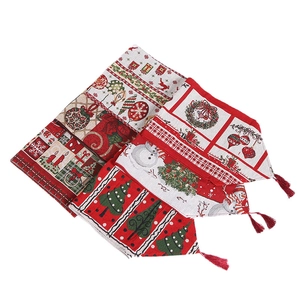 European Christmas table runner with festive elk and tree patterns in red and beige