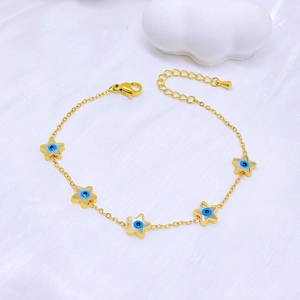 Golden titanium bracelet with blue star charms and evil eye details on white silk