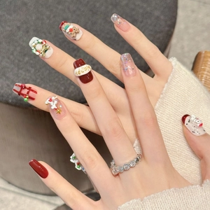 Handmade Christmas theme press-on nails featuring red plaid designs and 3D festive charms