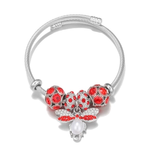 Detail of silver twisted rope bracelet featuring red rhinestone beads and bee charm
