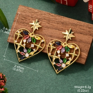 Detail shot of hollow heart star earrings with colorful rhinestones on a dark wood block