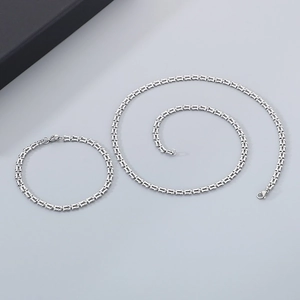Silver stainless steel rectangular link necklace and bracelet set displayed with gift box