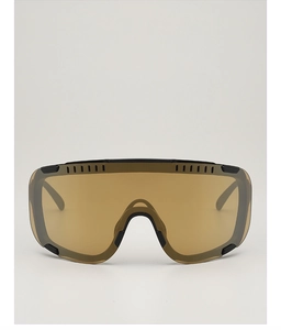 Close-up of black matte cycling glasses with dark amber lenses and breathable vents