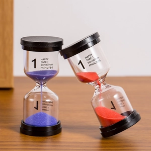 Red and purple 1-minute hourglass timers with black lids on a wooden surface