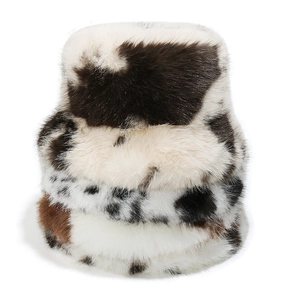 Plush faux fur winter bucket hats featuring cow print and leopard patterns in a stack