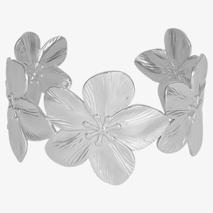 Macro shot of a silver floral cuff bracelet showing detailed interconnected petal textures