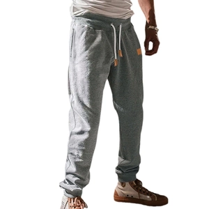 Men's grey jogger sweatpants with elastic drawstring waist and ribbed cuffs on white background