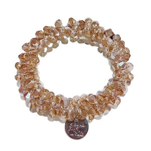 Elegant champagne crystal elastic hair tie and bracelet with metallic round charm tag