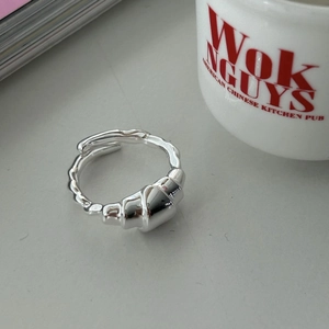 Detail of s925 silver croissant ring with an adjustable open design on a white table