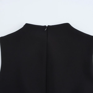 Detail of high crew neck and invisible back zipper on sleek sleeveless black bodycon dress