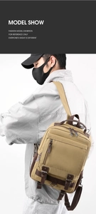 Detailed side view of khaki canvas backpack with brown leather straps and side mesh pockets