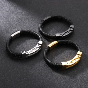Detail of men's braided leather bracelets with silver, gold, and black metal magnetic clasps