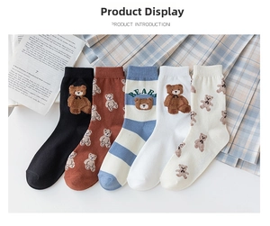 Detailed view of five cotton mid-calf socks featuring 3D teddy bear patches and patterns