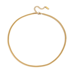 Macro detail of gold stainless steel fine chain necklace with engraved S.Steel tag