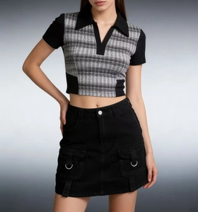 Detailed view of the black utility mini skirt with metallic ring buckles and cargo pockets