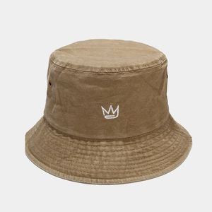 Macro view of crown embroidery and metal eyelets on vintage washed cotton bucket hat