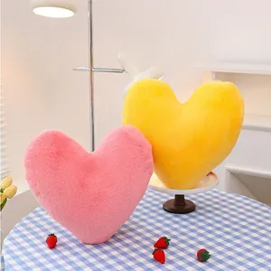 Plush heart-shaped throw pillows in pink and yellow for cozy home sofa decoration