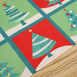 Detailed view of Christmas table mat with colorful tree pattern and fabric texture