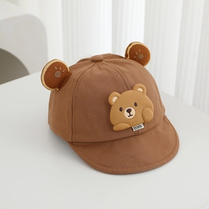 Close-up of brown cotton toddler cap with 3D cartoon bear and soft decorative ears