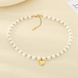 Detail of heart pendant pearl necklace with OT toggle clasp in polished gold-plated steel