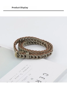 Close-up of olive green braided belt with vintage bronze U-buckle and V-weave texture