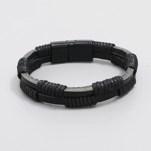 Detail of multi-layer black braided leather bracelet with square magnetic clasp