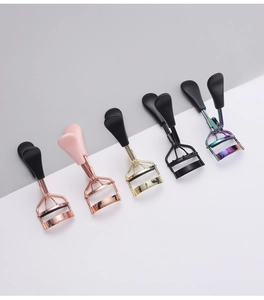 Detailed display of portable stainless steel eyelash curlers in five metallic finishes