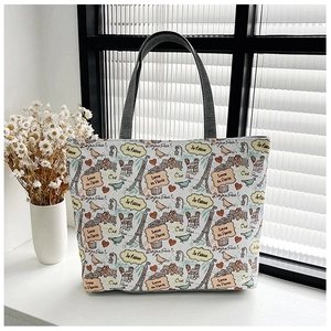 Detail of canvas tote bag with French Eiffel Tower prints and gray fabric handles