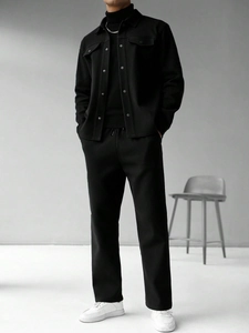 Full body view of a male model in black lapel jacket and matching trousers outfit