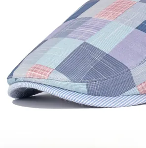 Macro detail of multi-color plaid newsboy cap showing blue pink knit pattern texture