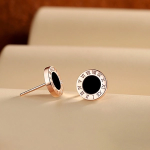 Rose gold Roman numeral stud earrings with black center in a minimalist modern style