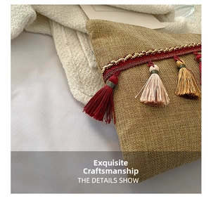 Detailed macro view of bohemian woven fabric bag with colorful silk tassels and ethnic bands
