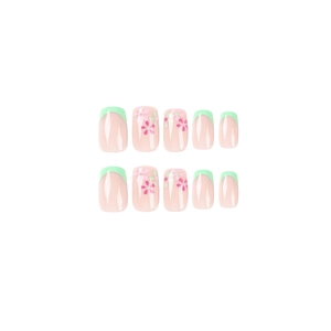 Green French manicure press-on nails with pink floral art and high-gloss finish