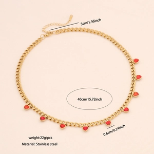 Detail shot of stainless steel gold chain necklace with small red heart pendants