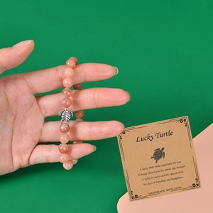Amazonite stone turtle bracelet with pink beads on a card for summer beach wear