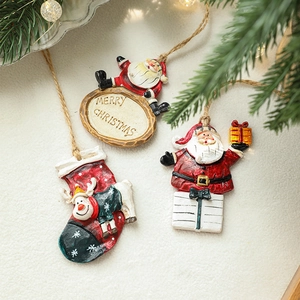 Festive resin Christmas ornaments with Santa and reindeer on white plush background