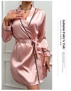 Elegant pink ice silk satin robe detail showing black piping trim and smooth texture