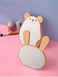 Detail of bear and rabbit shaped wooden makeup mirrors with natural glass surface