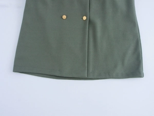 Detail shot of green wool coat showing double-breasted gold buttons and premium fabric