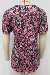 Detail view of the floral print pattern and back design of the casual crew neck short sleeve top