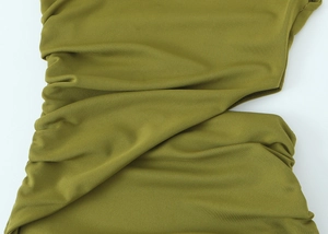 Dettaglio del tessuto in maglia verde oliva con texture premium e drappeggio morbido
