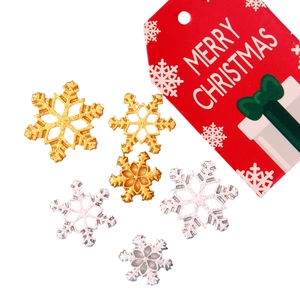 Glittering gold and silver snowflake charms with Merry Christmas tag for DIY decor