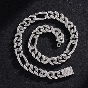 Detail of iced out infinity link Cuban chain necklace with sparkling crystals on black