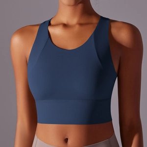 Detail of navy blue racerback sports bra showing supportive wide straps and matte texture