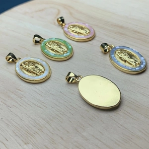 Oval Virgin Mary pendants in gold with pink, green, white, and blue enamel borders