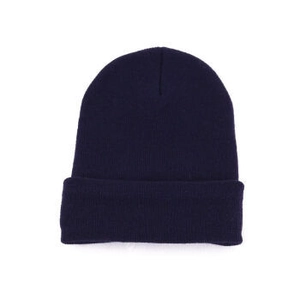 Detailed knit texture of dark blue winter beanie hat with classic folded cuff design