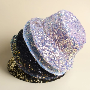 Close-up of sparkling sequin bucket hats in purple, black, and gold color options