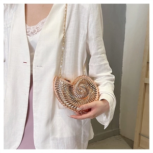 Fashionable rose gold snail-shaped crossbody bag with a metal chain shown on model